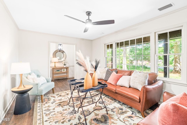 living area with visible vents, crown molding, and a healthy amount of sunlight