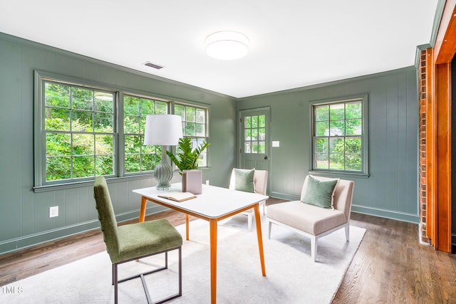 office area featuring visible vents, ornamental molding, baseboards, and wood finished floors