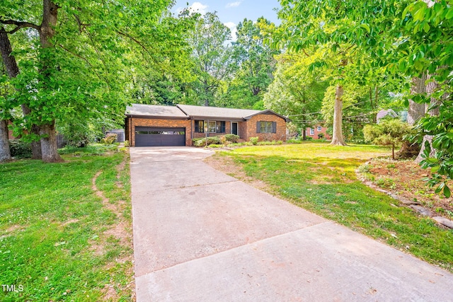 ranch-style home with an attached garage, a front lawn, brick siding, and concrete driveway