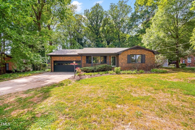 ranch-style house with an attached garage, aphalt driveway, a front yard, and brick siding