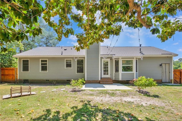 rear view of house with fence, crawl space, entry steps, a patio area, and a yard