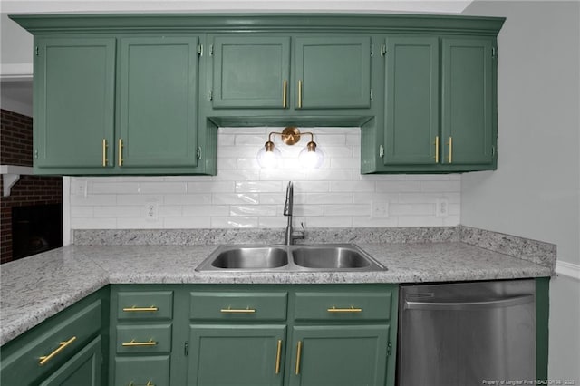 kitchen featuring stainless steel dishwasher, light countertops, a sink, and green cabinets