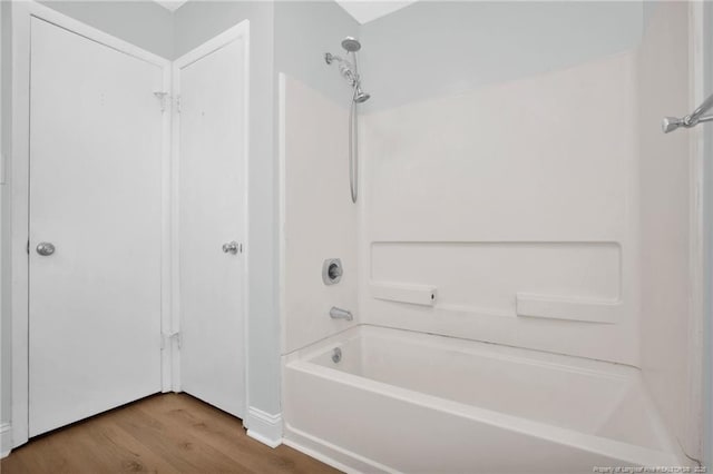 full bath with bathing tub / shower combination and wood finished floors
