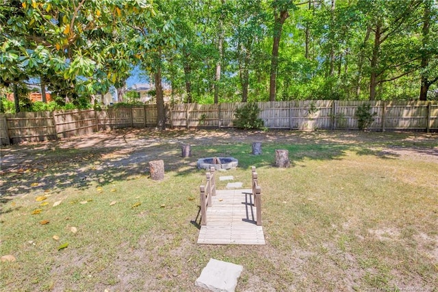 view of yard featuring fence and a fire pit