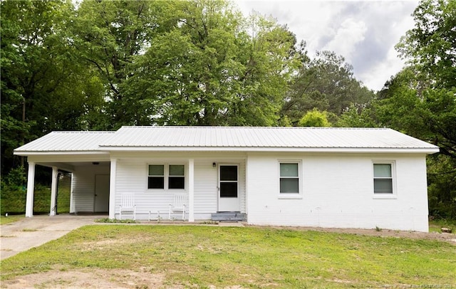 3254 Blossom Dr, Fayetteville, NC 28306 - ranch-style house featuring driveway, metal roof, a front yard, and an attached carport