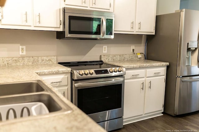 3254 Blossom Dr, Fayetteville, NC 28306 - kitchen with light countertops, stainless steel appliances, and white cabinets