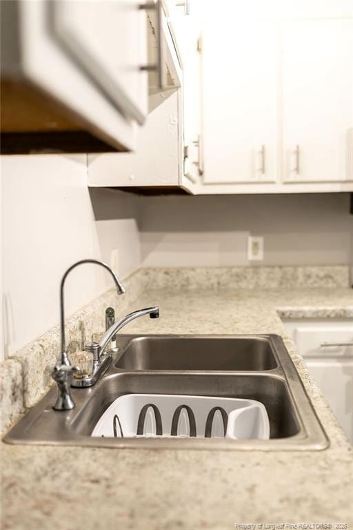 3254 Blossom Dr, Fayetteville, NC 28306 - interior details with light countertops, white cabinets, and a sink