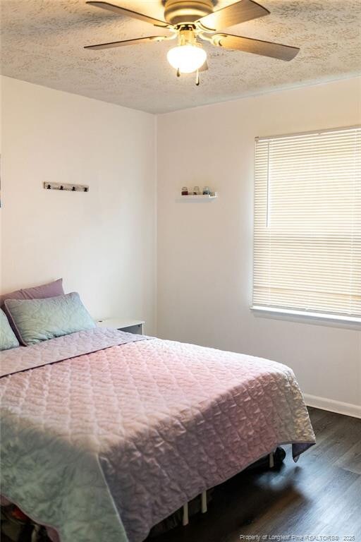 3254 Blossom Dr, Fayetteville, NC 28306 - bedroom featuring baseboards, a ceiling fan, and wood finished floors