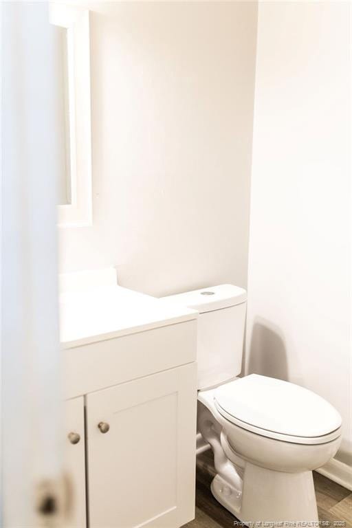 3254 Blossom Dr, Fayetteville, NC 28306 - bathroom featuring toilet, wood finished floors, and vanity