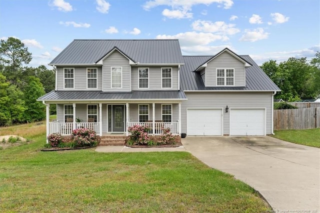 view of front facade featuring a front lawn, fence, driveway, and metal roof