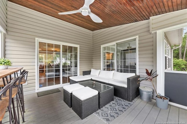 deck with outdoor lounge area and a ceiling fan
