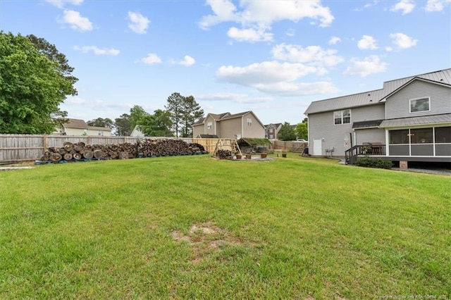 view of yard with a fenced backyard and a sunroom