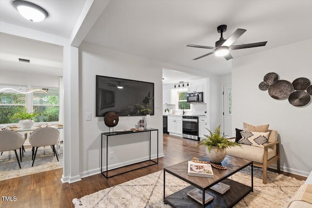 3907 Inwood Dr, Durham, NC 27705 - living room with ceiling fan, dark wood-type flooring, and baseboards