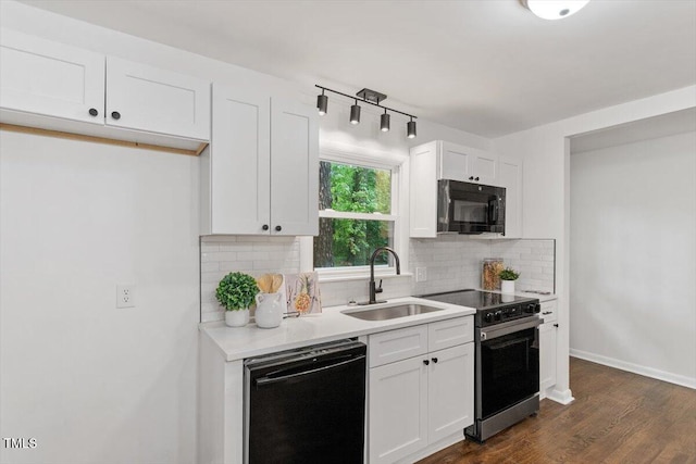 3907 Inwood Dr, Durham, NC 27705 - kitchen featuring black appliances, a sink, decorative backsplash, dark wood-style floors, and white cabinetry