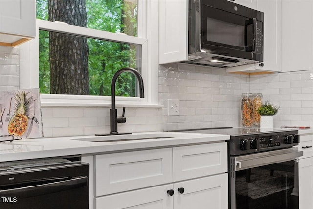 3907 Inwood Dr, Durham, NC 27705 - kitchen featuring black microwave, dishwasher, electric range, a sink, and white cabinetry