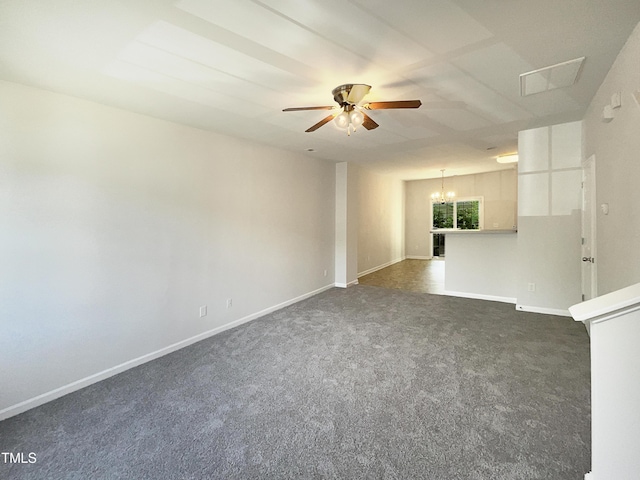 empty room featuring baseboards, ceiling fan with notable chandelier, and dark colored carpet