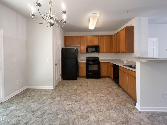 kitchen featuring stone finish flooring, light countertops, baseboards, black appliances, and a chandelier