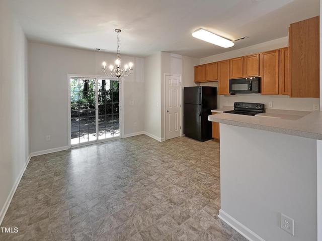kitchen with an inviting chandelier, light countertops, a peninsula, baseboards, and black appliances