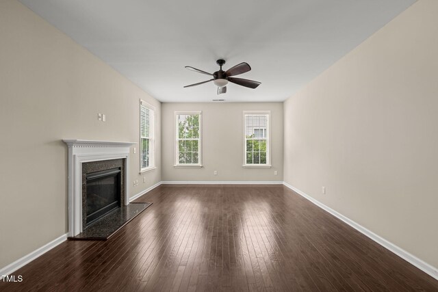 5011 Peachtree Town Ln, Knightdale, NC 27545 - unfurnished living room with ceiling fan, baseboards, a premium fireplace, and dark wood finished floors