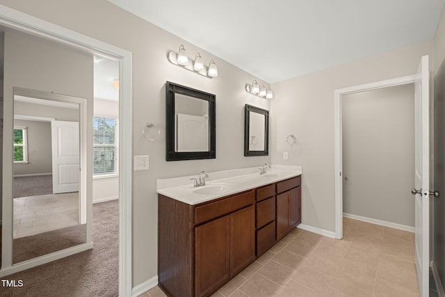 5011 Peachtree Town Ln, Knightdale, NC 27545 - bathroom with double vanity, baseboards, and tile patterned flooring