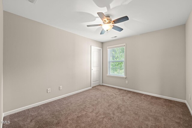 5011 Peachtree Town Ln, Knightdale, NC 27545 - spare room with carpet, baseboards, and ceiling fan