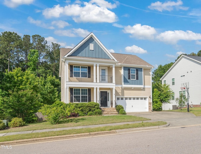 5011 Peachtree Town Ln, Knightdale, NC 27545 - view of front of property with board and batten siding, driveway, an attached garage, and a balcony