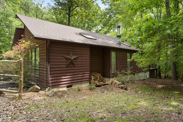 view of front facade with a shingled roof and crawl space