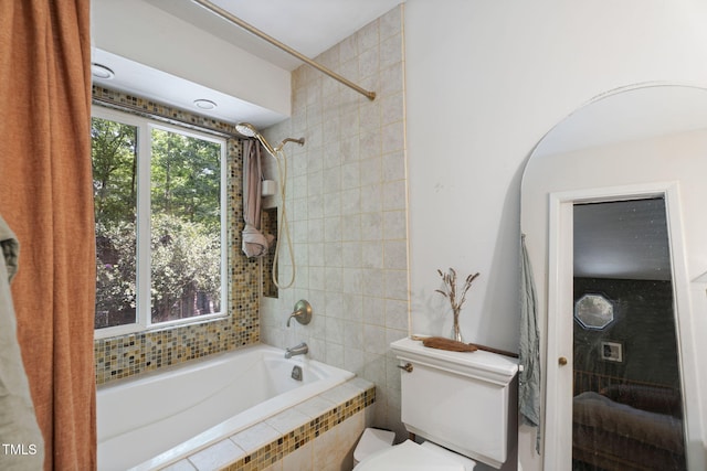full bathroom with tiled shower / bath and toilet