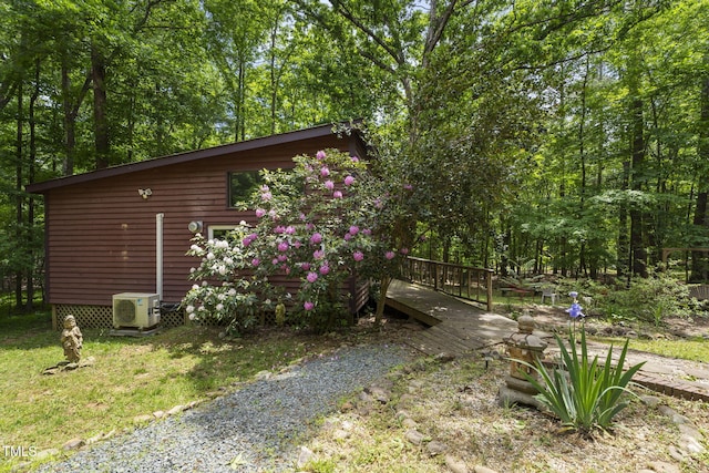 view of side of property with ac unit and a deck