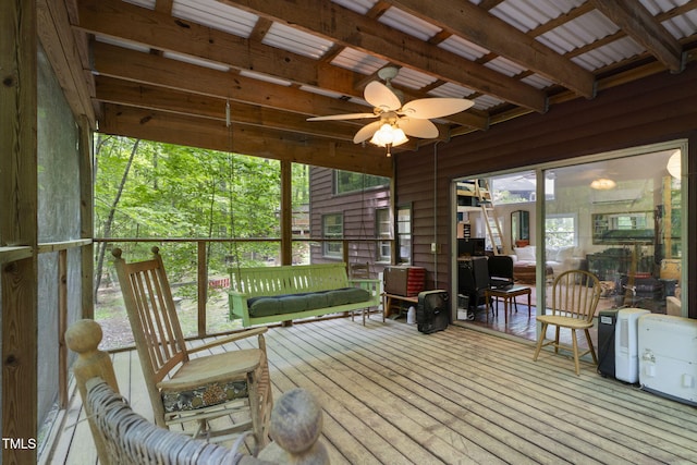 sunroom / solarium featuring beamed ceiling