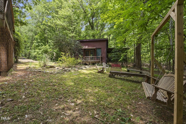 view of grassy yard featuring a deck