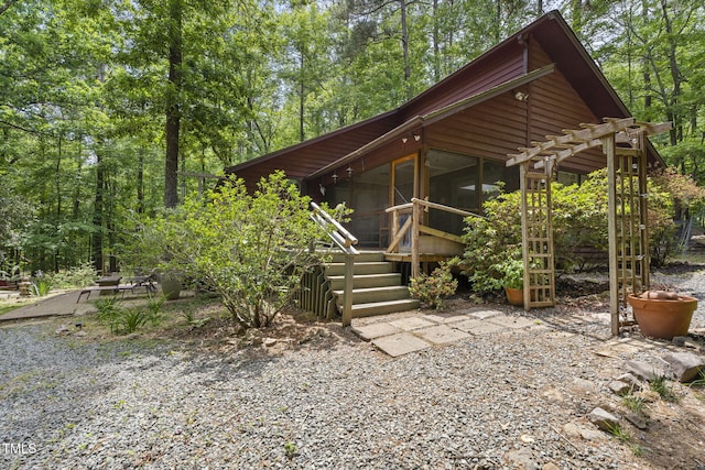 view of front of home featuring a pergola and a sunroom