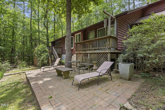 view of patio / terrace with stairs and a deck