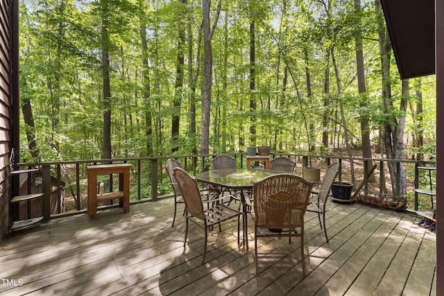 wooden terrace with outdoor dining area