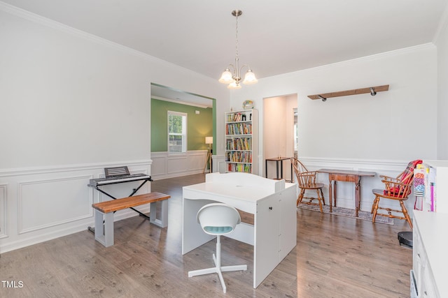 dining space featuring wainscoting, ornamental molding, and light wood finished floors