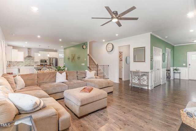 living room featuring crown molding, stairs, wood finished floors, recessed lighting, and a ceiling fan