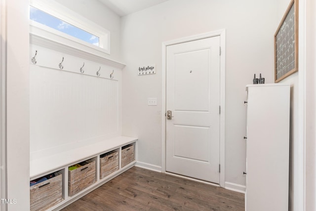 mudroom featuring dark wood-style flooring and baseboards