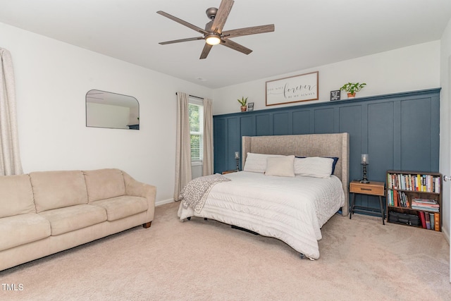 bedroom with baseboards, a ceiling fan, and light colored carpet