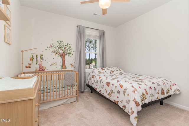 bedroom featuring carpet floors, a ceiling fan, baseboards, and visible vents