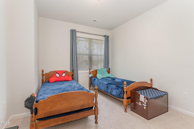 bedroom with baseboards and carpet flooring