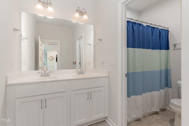 full bathroom featuring a sink, tile patterned flooring, toilet, and double vanity