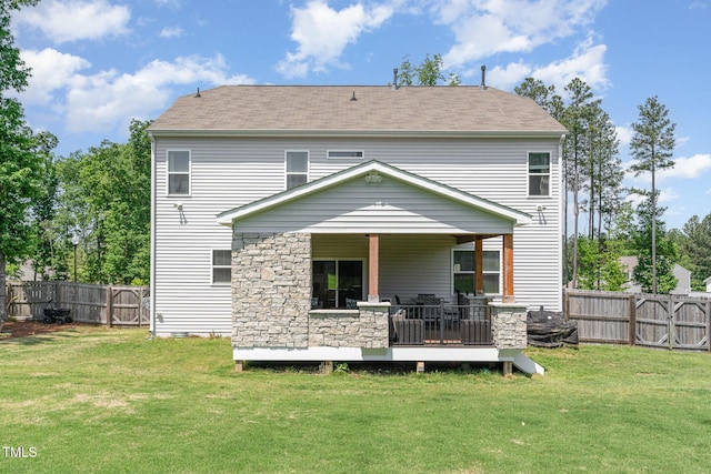 back of property featuring a yard, a shingled roof, and a fenced backyard