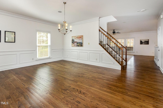 empty room featuring stairway, a chandelier, crown molding, dark wood finished floors, and ceiling fan