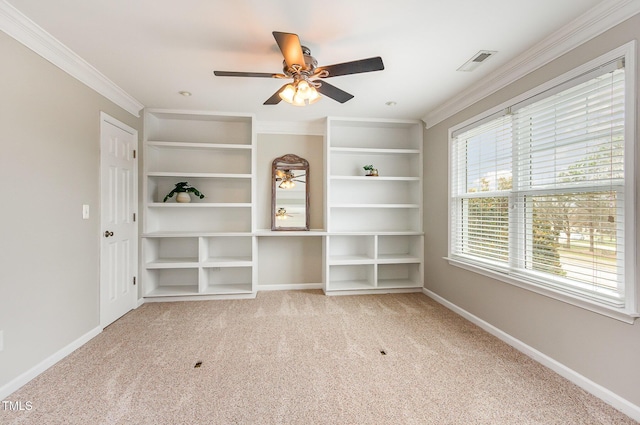 unfurnished room featuring crown molding, ceiling fan, carpet flooring, baseboards, and built in features