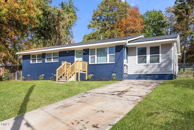 ranch-style home featuring a front lawn, fence, brick siding, crawl space, and concrete driveway