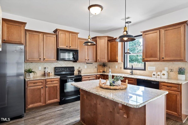206 Wynngate Dr, Cameron, NC 28326 - kitchen featuring black appliances, dark wood-style floors, pendant lighting, and light stone countertops