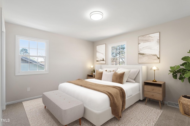 bedroom featuring light colored carpet, baseboards, and visible vents