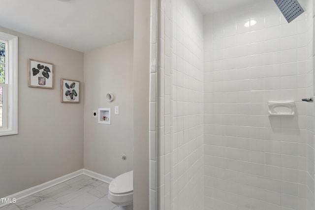bathroom featuring baseboards, a tile shower, toilet, and marble finish floor