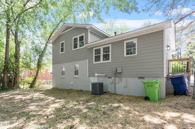 rear view of house featuring cooling unit