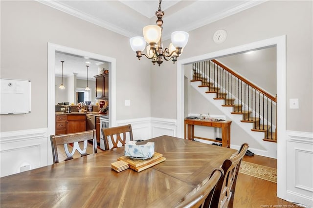 110 Wynngate Dr, Cameron, NC 28326 - dining room featuring crown molding, stairs, wainscoting, wood finished floors, and a chandelier